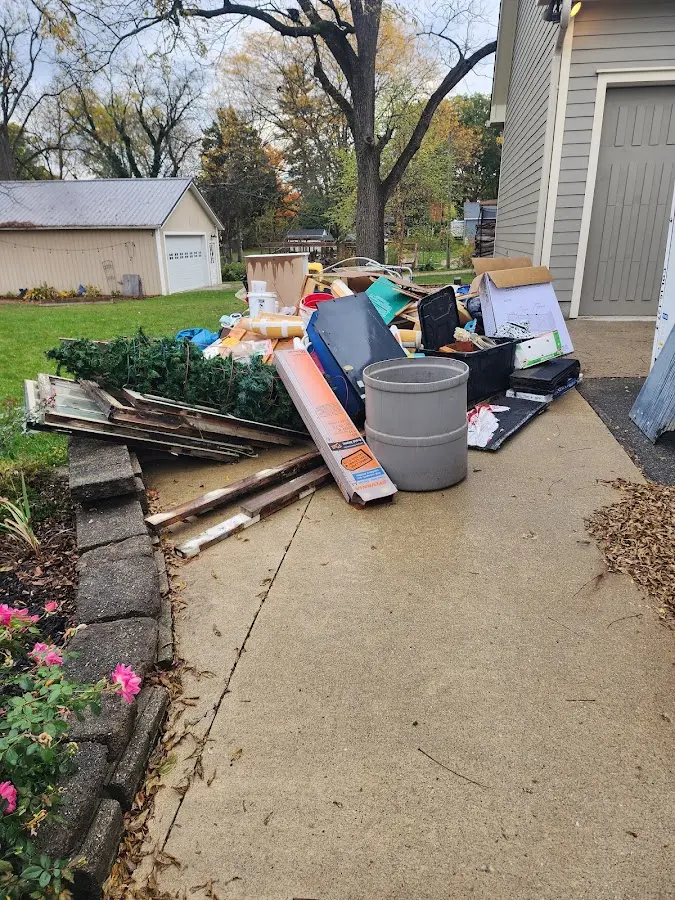 Dumpster being loaded with debris for Estate Cleanout Dumpster Rental in Lakewood